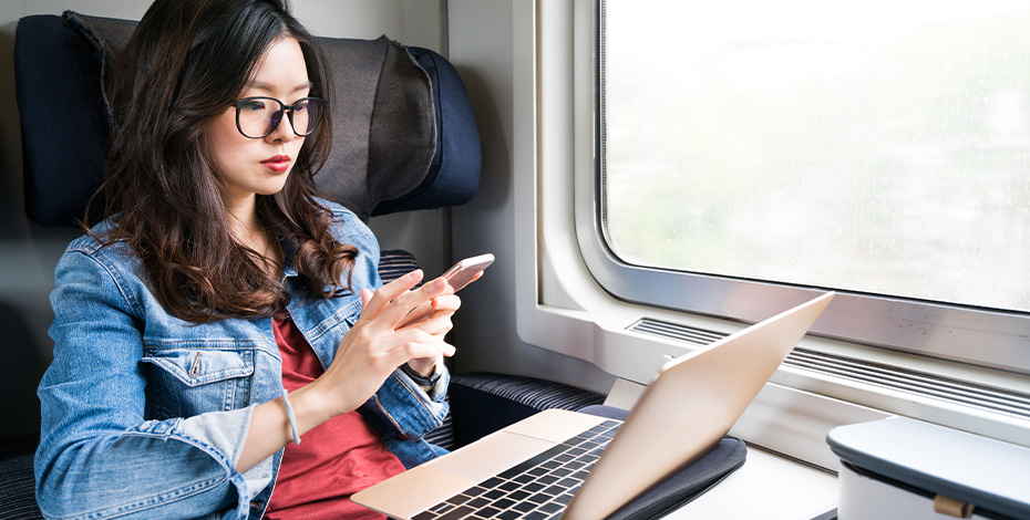 Person on train using multiple devices - Asset security - ExactTrak